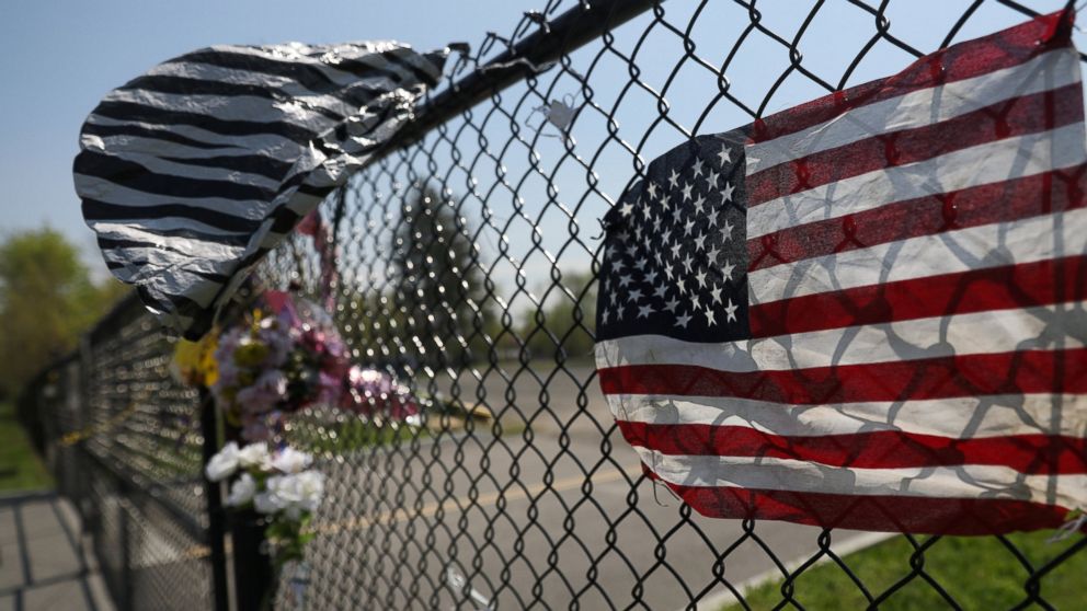 A makeshift memorial stands outside a park, where bodies of four men were found on April 13, in Central Islip, New York, April 28, 2017. Local media quoted authorities as saying the Central American-based Mara Salvatrucha (MS-13) gang is responsible of the killings.