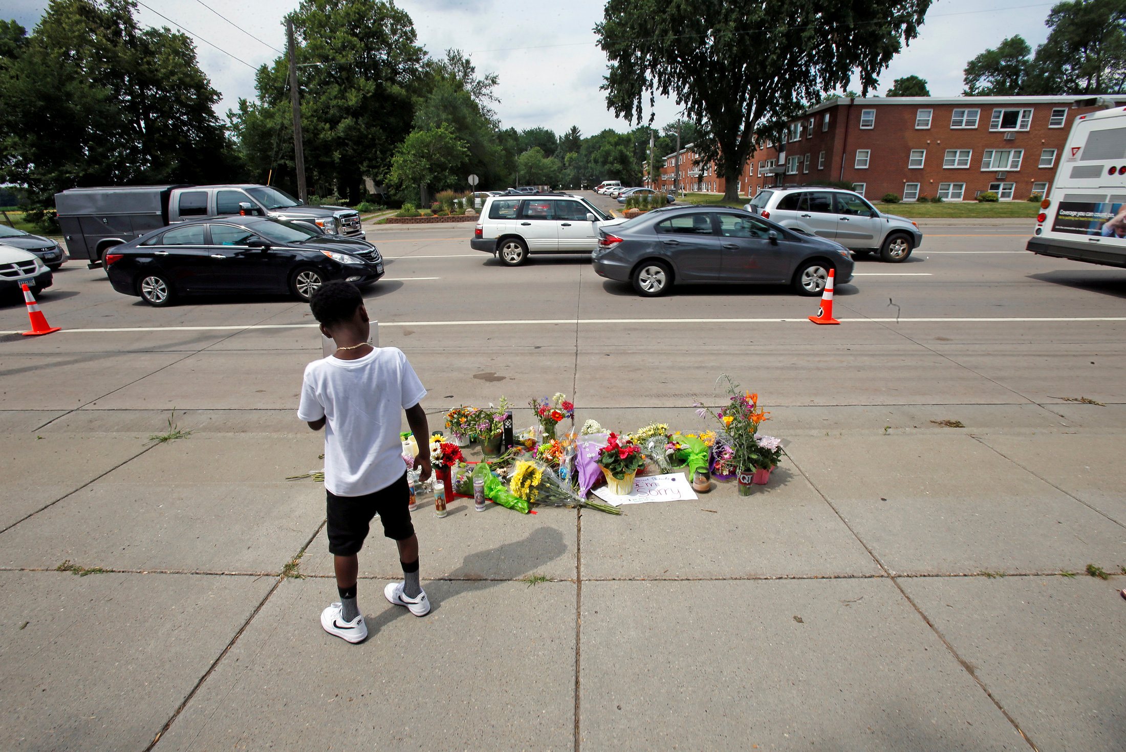PHOTO: A boy stands at a make-shift memorial at the site of the police shooting of Philando Castile in Falcon Heights, Minnesota, July 7, 2016.