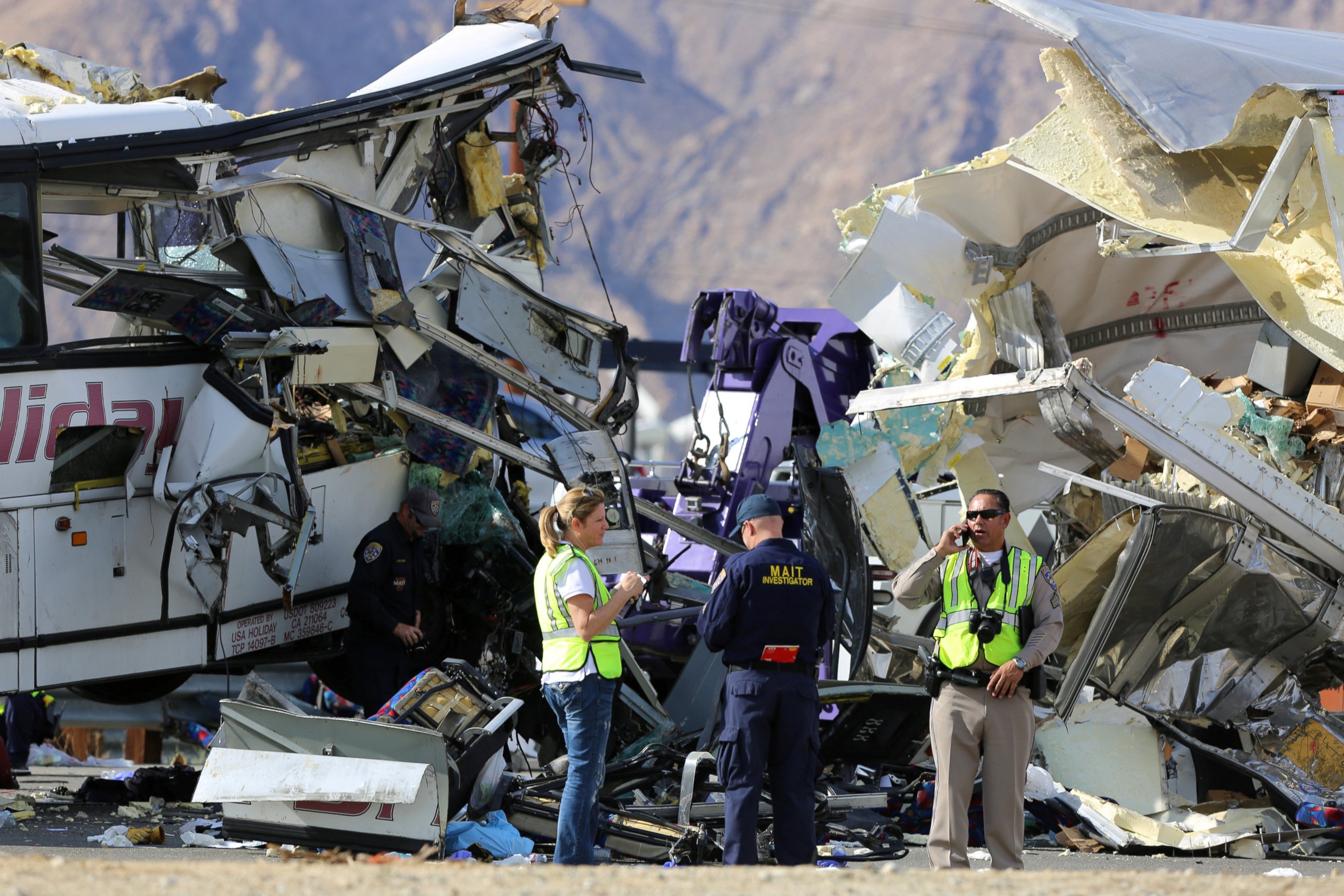 PHOTO: Investigators speak to each other at the scene of a mass casualty bus crash on the westbound Interstate 10 freeway near Palm Springs, California, Oct. 23, 2016.