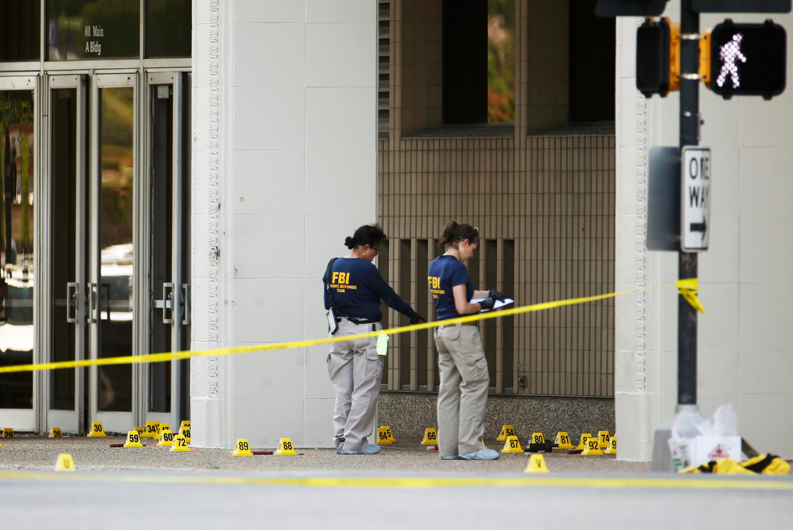 PHOTO: FBI investigators look over the crime scene in Dallas, July 8, 2016, following a Thursday night shooting incident that killed five police officers.  