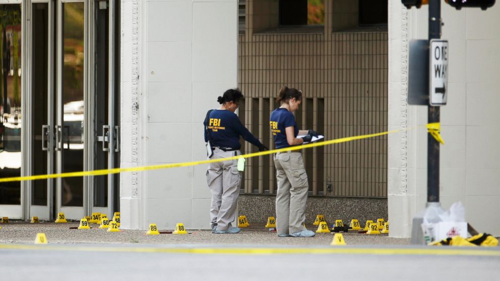 FBI investigators look over the crime scene in Dallas, July 8, 2016, following a Thursday night shooting incident that killed five police officers.  