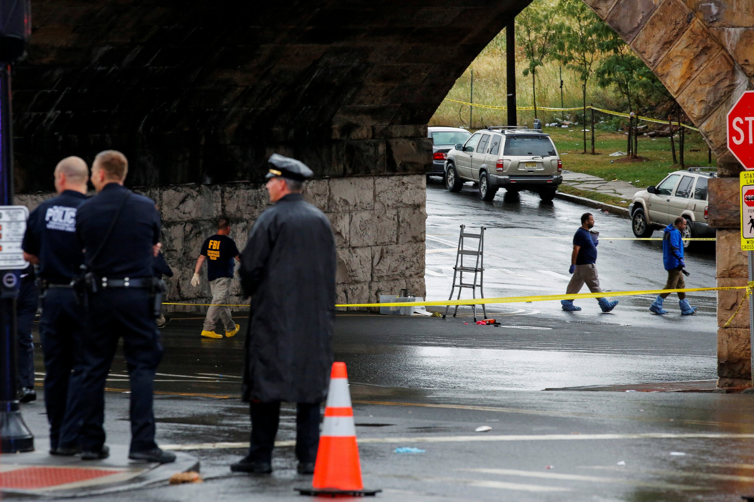 PHOTO: Federal Bureau of Investigation (FBI) officials and police officers walk near the area where an explosive device left at a train station was detonated by the authorities in Elizabeth, New Jersey, Sept. 19, 2016. 