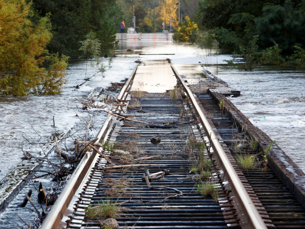 PHOTO: Debris swept downriver by the rising Tar River litter a flooded rail bridge crossing the river from Tarboro into Princeville as the river crests in the aftermath of Hurricane Matthew, in Tarboro, North Carolina, on Oct. 13, 2016.
