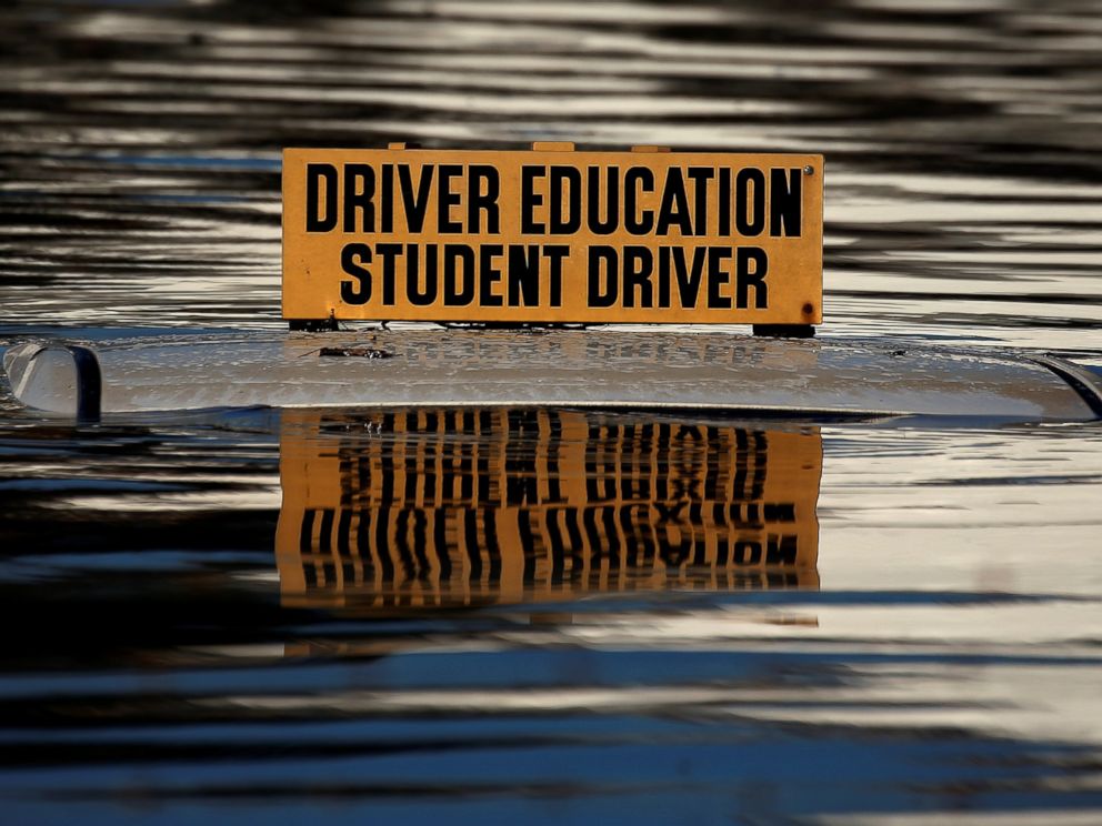PHOTO: The roof of a student driver car is pictured partly underwater as a result of Hurricane Matthew in Lumberton, North Carolina, on Oct. 10, 2016.
