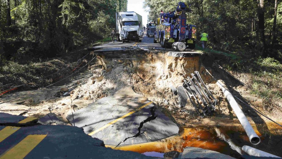 PHOTO: A semi truck that drove past a barricade is removed from a washed away road on Highway 117 as flood waters in the wake of Hurricane Matthew continue to rise in Goldsboro, North Carolina, Oct. 10, 2016. 