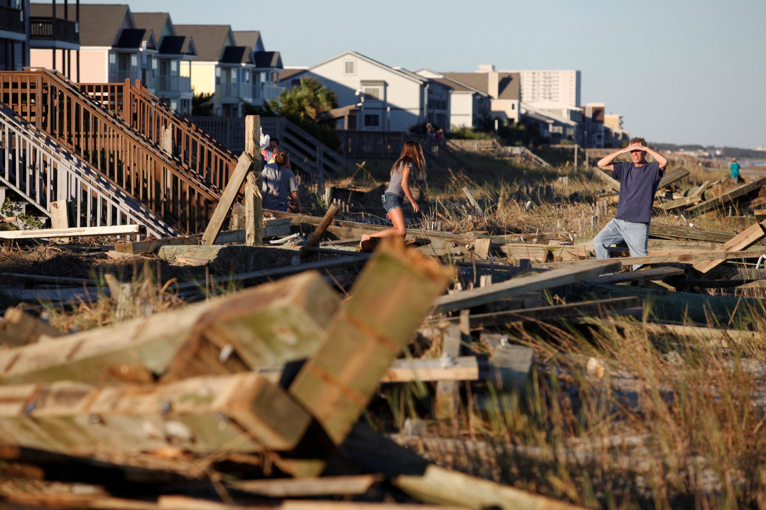 PHOTO: People look through the debris from the pier damaged by Hurricane Matthew in Surfside Beach, South Carolina, Oct. 9, 2016. 