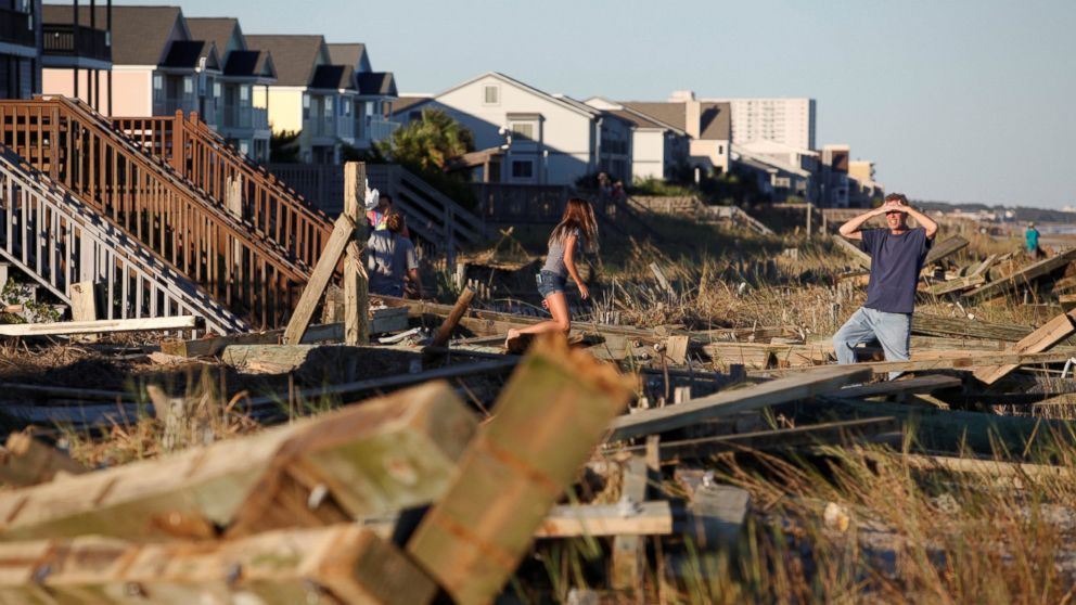 PHOTO: People look through the debris from the pier damaged by Hurricane Matthew in Surfside Beach, South Carolina, Oct. 9, 2016. 