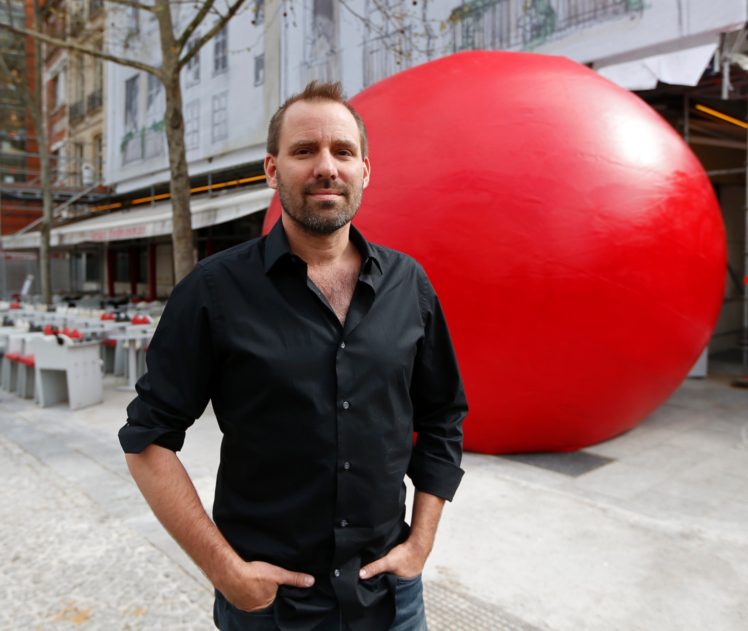 PHOTO: Artist Kurt Perschke poses with his huge red ball as part of his RedBall Project in Paris on April 18, 2013.