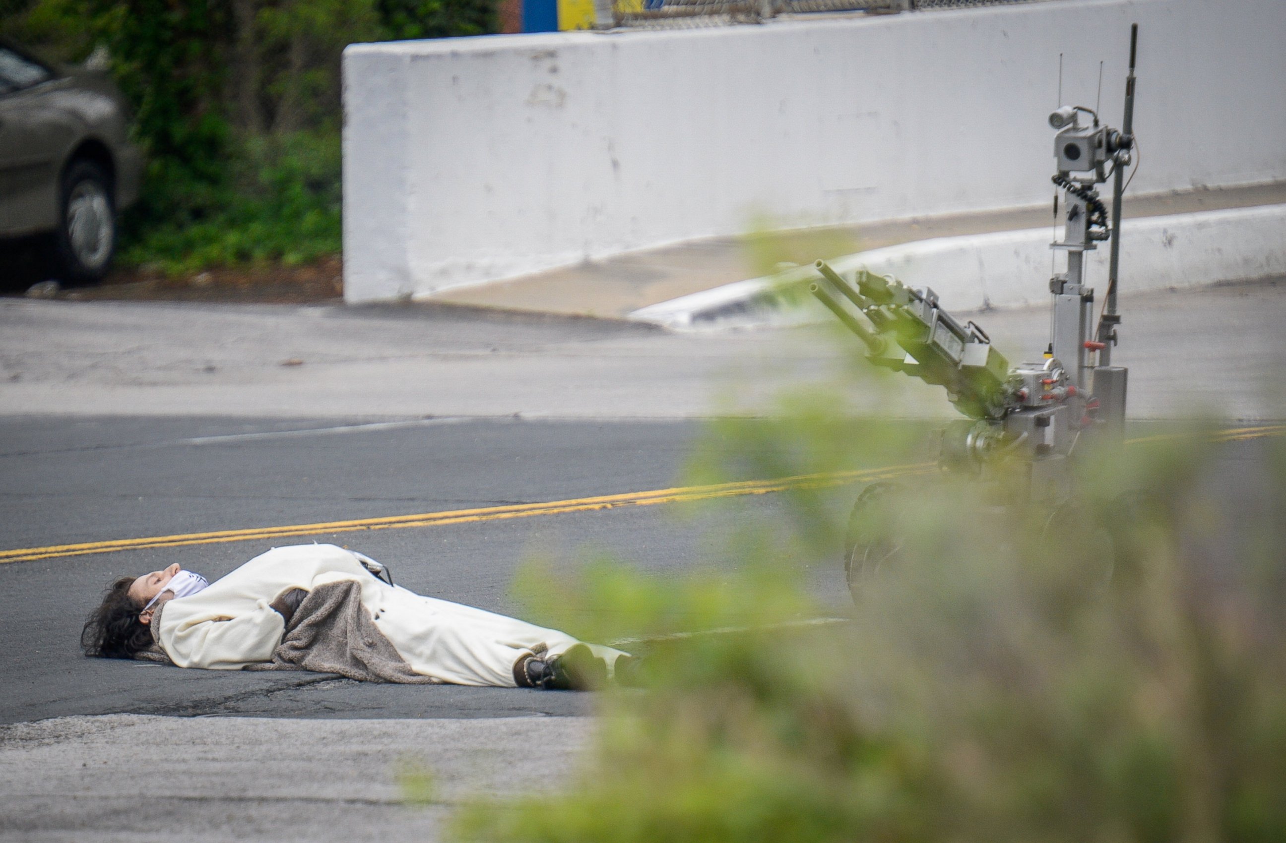 PHOTO: A man, claiming to have a bomb, lays in the street outside of the Fox45 television station, which was evacuated due to a bomb threat, in Baltimore, April 28, 2016.  