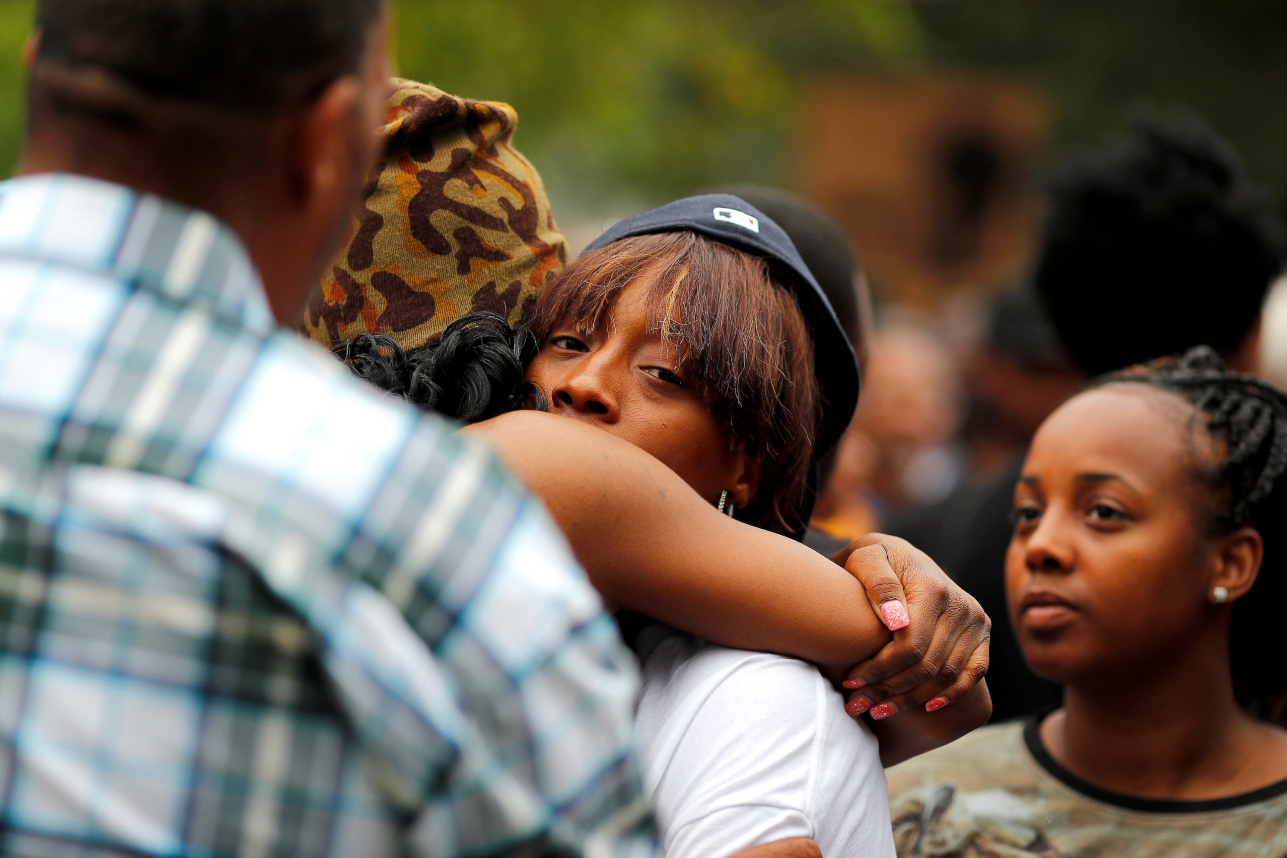PHOTO: Diamond Reynolds, girlfriend of Philando Castile, gets a hug as people gather to protest the fatal shooting by Minneapolis area police during a traffic stop, July 7, 2016, in St. Paul, Minnesota. 