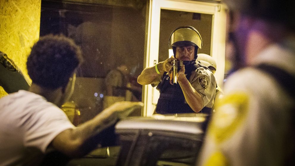 St. Louis County police officers arrest an anti-police demonstrator, Aug.11, 2015, in Ferguson, Mo.