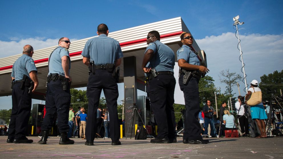 Police officers stand by after the announcement of the name of the officer involved in the shooting of Michael Brown in Ferguson, Missouri, Aug. 15, 2014.