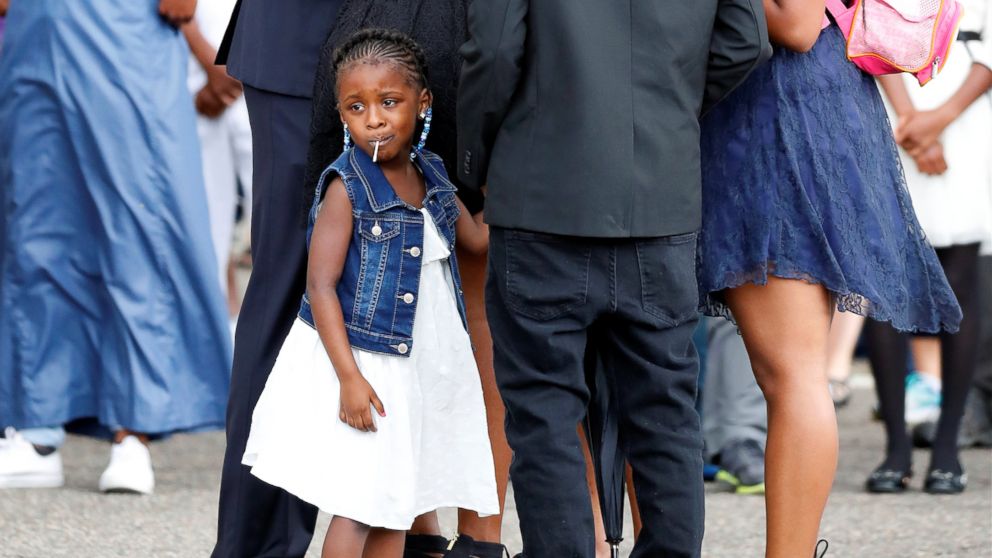 Diamond Reynolds' daughter looks on as the funeral procession for Philando Castile travels from the Brooks funeral home to the St Paul Cathedral in St Paul, Minnesota, July 14, 2016.