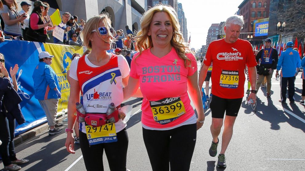 PHOTO: 2013 Boston Marathon survivor Heather Abbott, right, finishes the 118th Boston Marathon with Erin Chatham, one of the people who helped rescue Abbott and who ran the race this year in Boston, April 21, 2014.