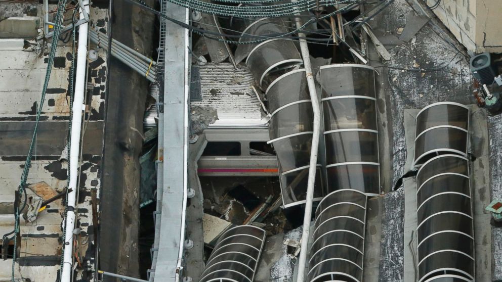 PHOTO: A derailed New Jersey Transit train is seen under a collapsed roof after it derailed and crashed into the station in Hoboken, New Jersey, Sept. 29, 2016.