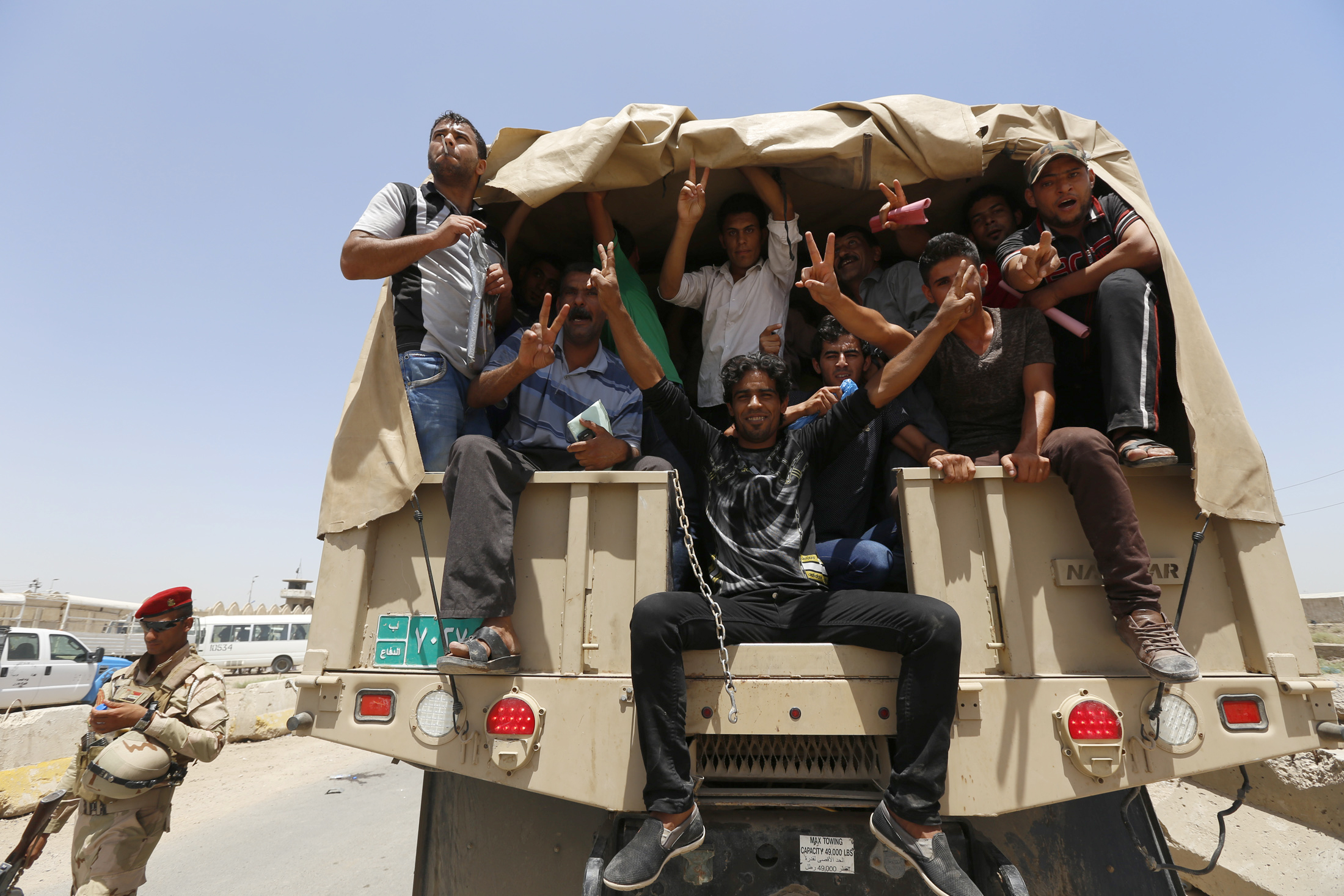 PHOTO: Volunteers, who have joined the Iraqi Army to fight against the predominantly Sunni militants who have taken over Mosul and other Northern provinces, travel in army trucks in Baghdad June 14, 2014.