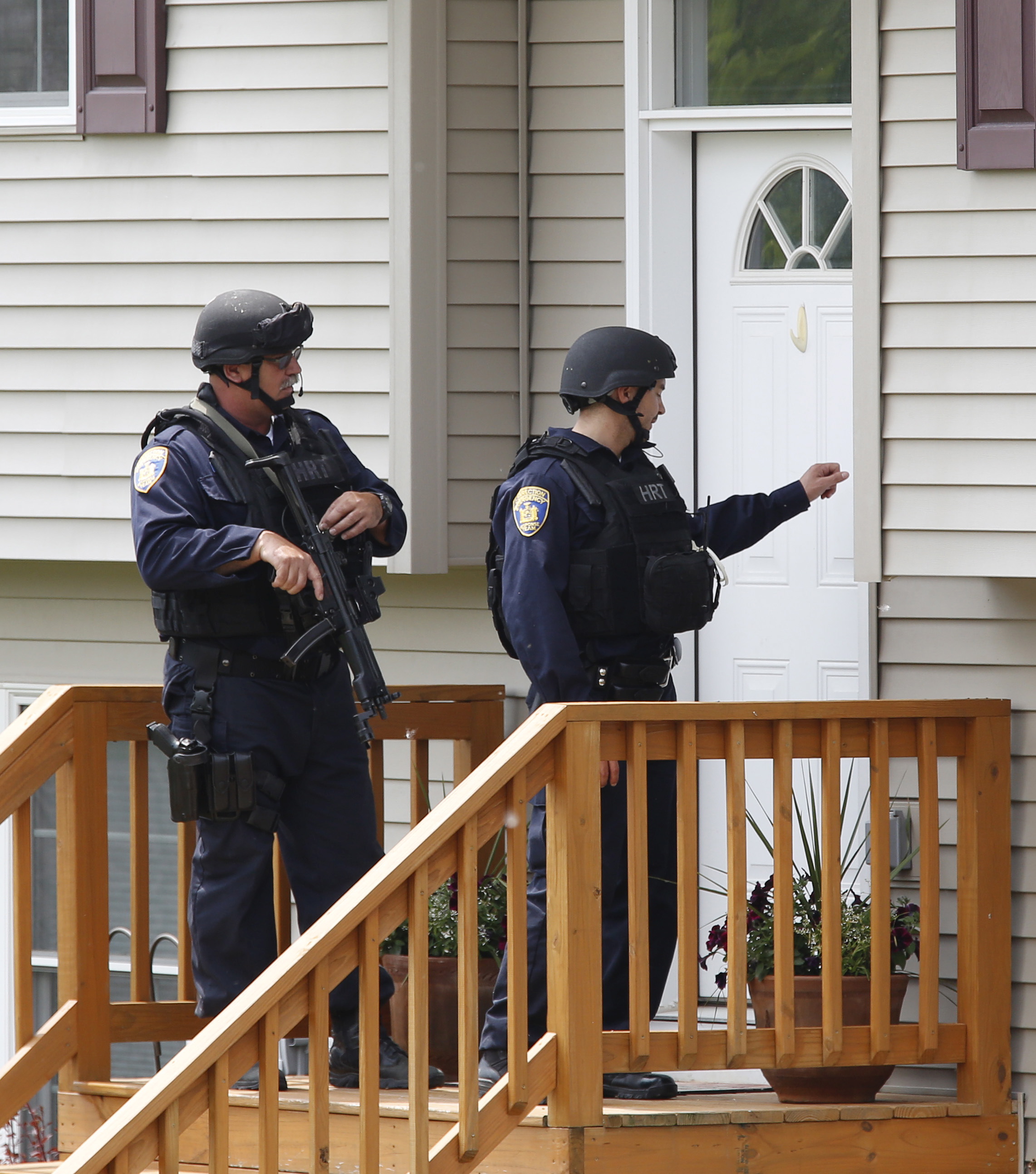 PHOTO: Law enforcement officials knock on the door of a home while searching a street near the Clinton Correctional Facility in Dannemora, New York June 10, 2015.