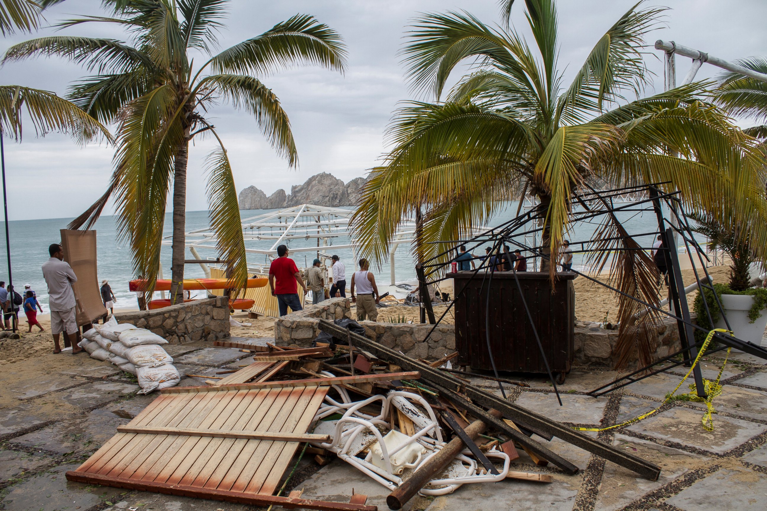 PHOTO: Residents stand next to debris of a restaurant in the aftermath of Hurricane Newton in Los Cabos, Mexico, Sept. 6, 2016.