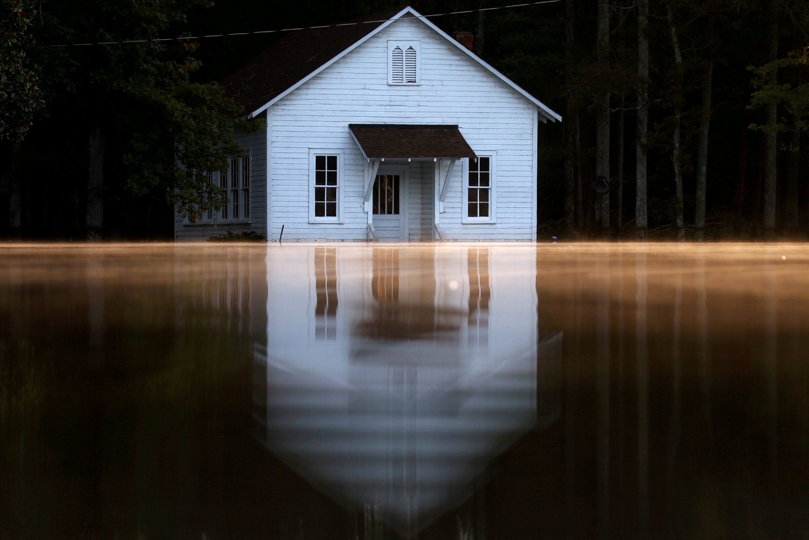 PHOTO: Mist rises off the water as a flooded building is pictured after Hurricane Matthew passes in Lumberton, North Carolina, Oct. 11, 2016.