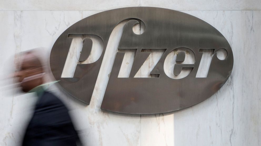 A man walks past Pfizer's world headquarters in New York, April 28, 2014. 