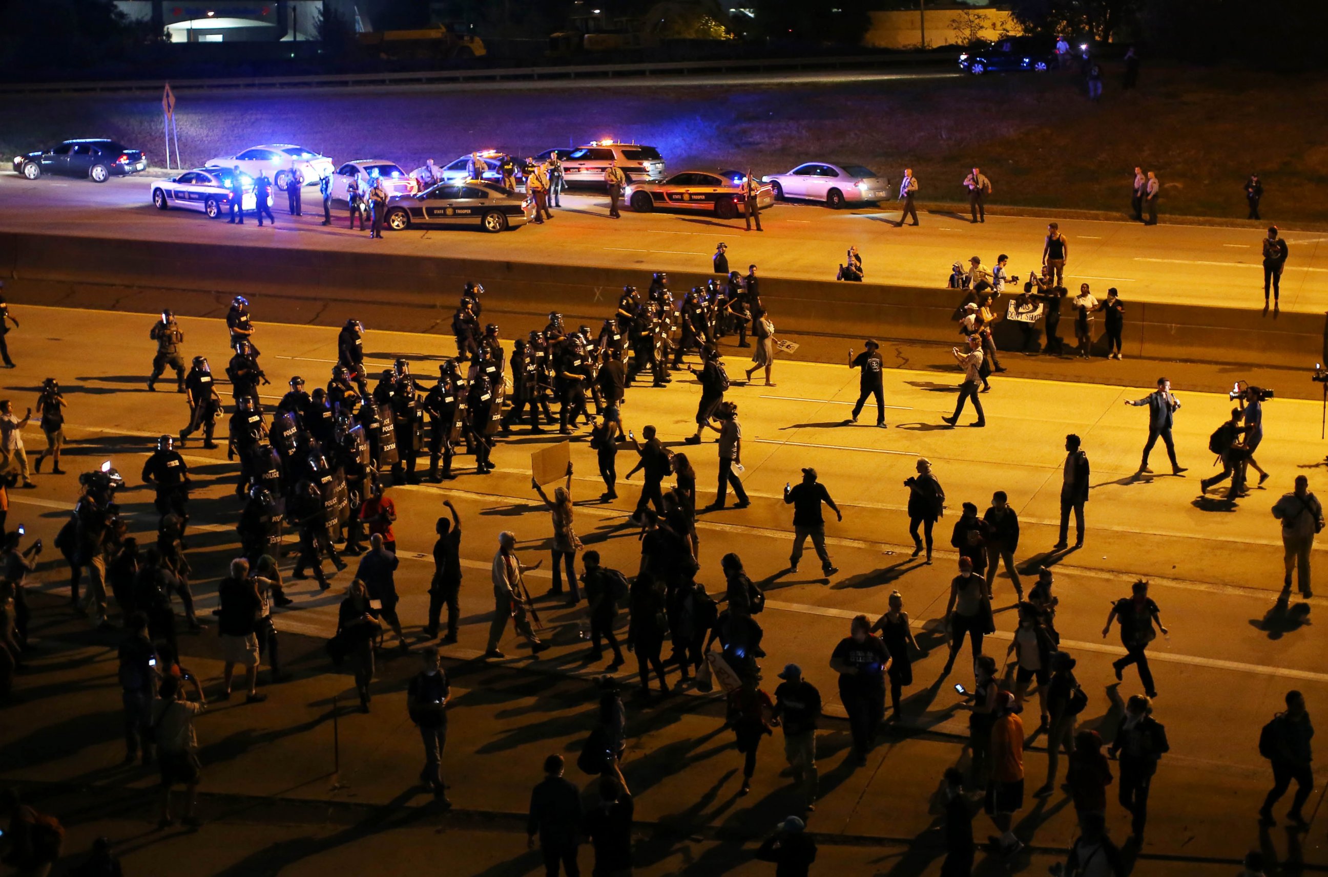 PHOTO: Riot police push protesters off the highway during another night of protests over the police shooting of Keith Scott in Charlotte, North Carolina. Sept. 22, 2016. 