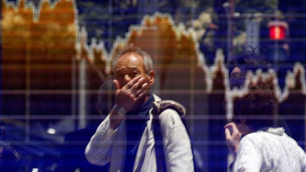 PHOTO: A man is reflected in an electronic board showing the graph of the recent fluctuations of the Tokyo Stock Price Index in Tokyo, June 27, 2016.