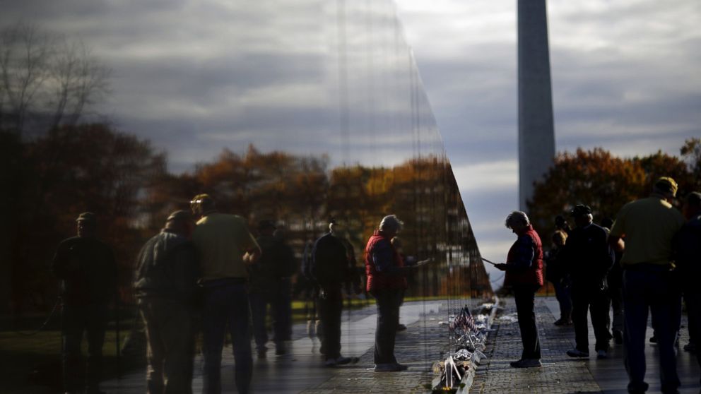 People visit the Vietnam Veterans Memorial wall on Veterans day in Washington, Nov. 11, 2015.