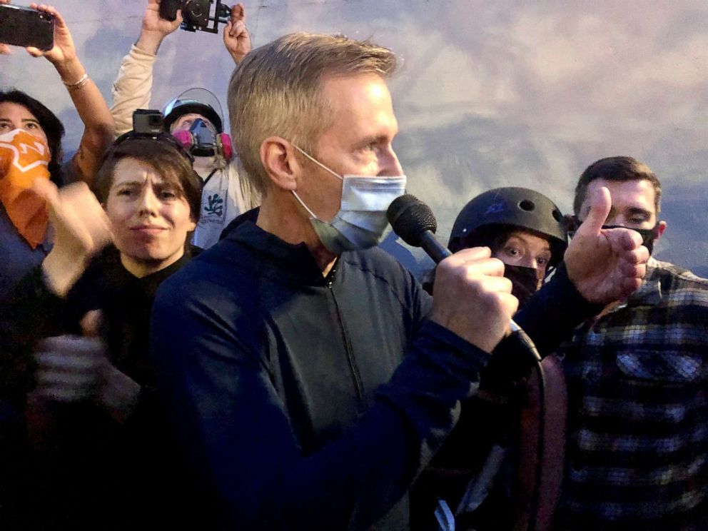 PHOTO: Mayor Ted Wheeler speaks to people gathered in downtown Portland, Ore., Wednesday, July 22, 2020. 