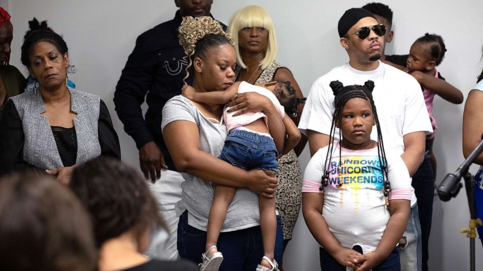 PHOTO: Rayshard Brooks widow Tomika Miller holds one of her daughters as family lawyers speaks to media , June 15, 2020, in Atlanta. 