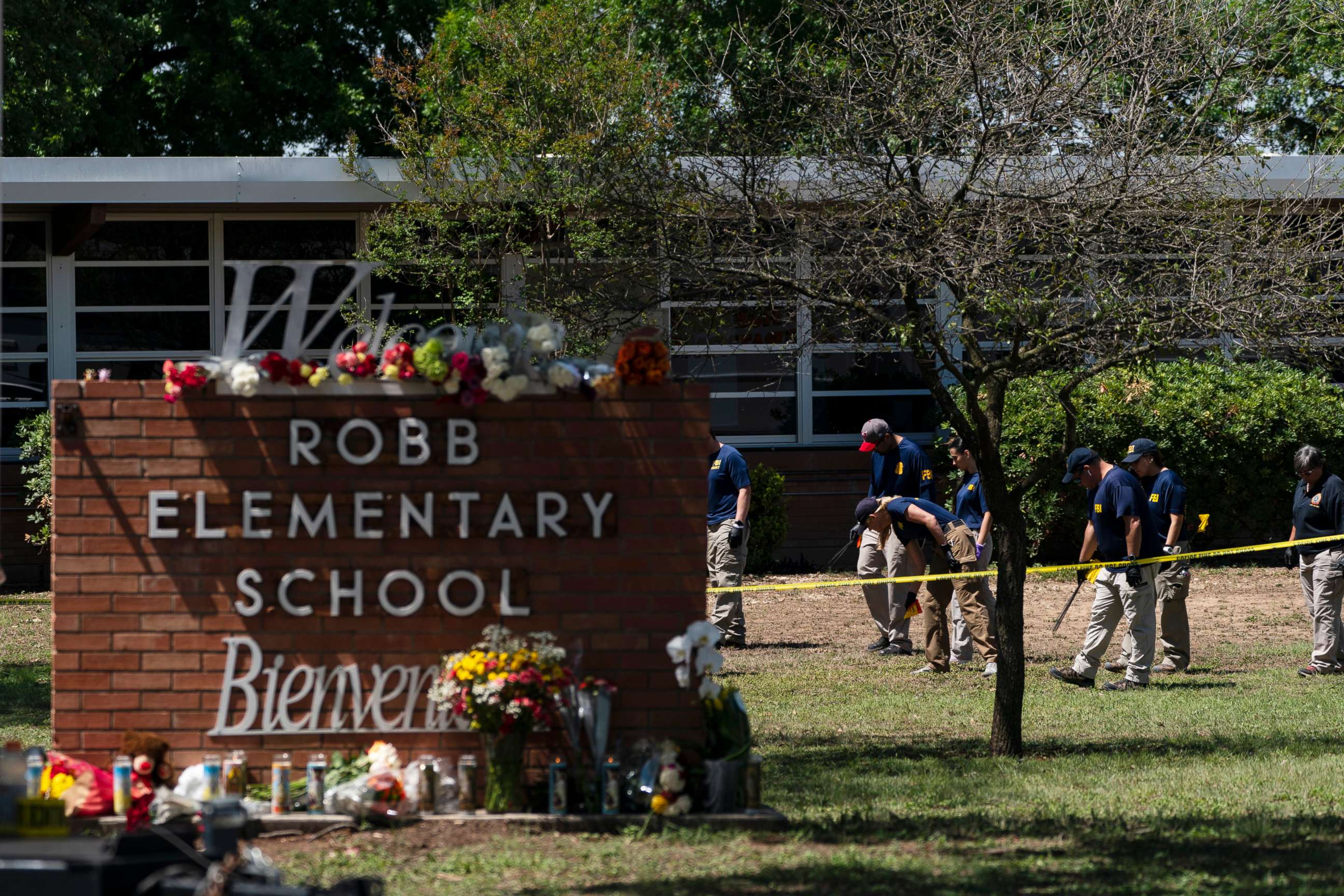 Investigators search for evidences outside Robb Elementary School in Uvalde, Texas, Wednesday, May 25, 2022. A gunman fatally shot 19 children and two teachers at the school the day before on May 24. 