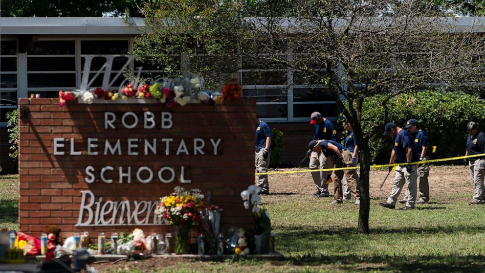 Investigators search for evidences outside Robb Elementary School in Uvalde, Texas, Wednesday, May 25, 2022. A gunman fatally shot 19 children and two teachers at the school the day before on May 24. 