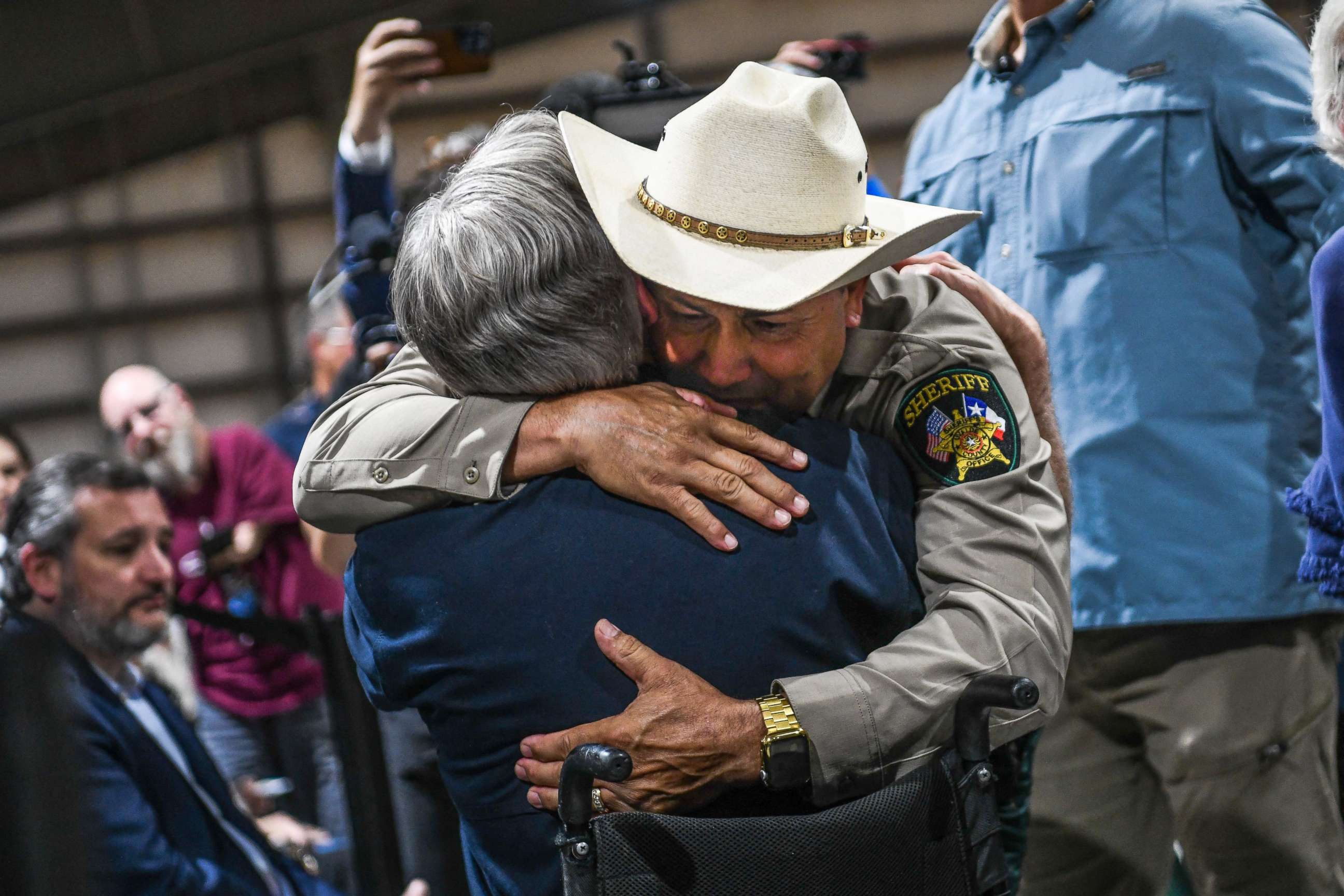 PHOTO: Uvalde County Sheriff Ruben Nolasco hugs Texas Governor Greg Abbott as they attend a vigil for the victims of the mass shooting at Robb Elementary School, May 25, 2022, in Uvalde, Texas.