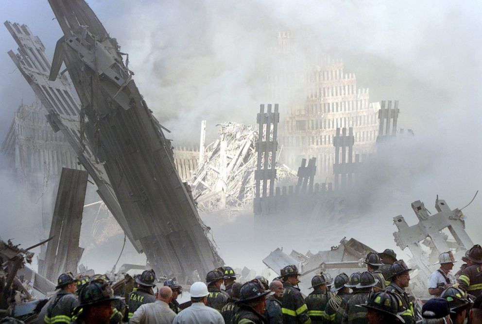 PHOTO: A group of firefighters stand on the street near the destroyed World Trade Centre in New York, Sept. 11, 2001. 