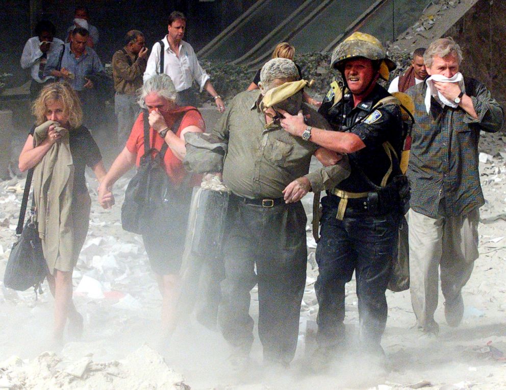 PHOTO: Kayla Bergeron and other people walk away from the World Trade Centre tower in New York, Sept. 11, 2001. 