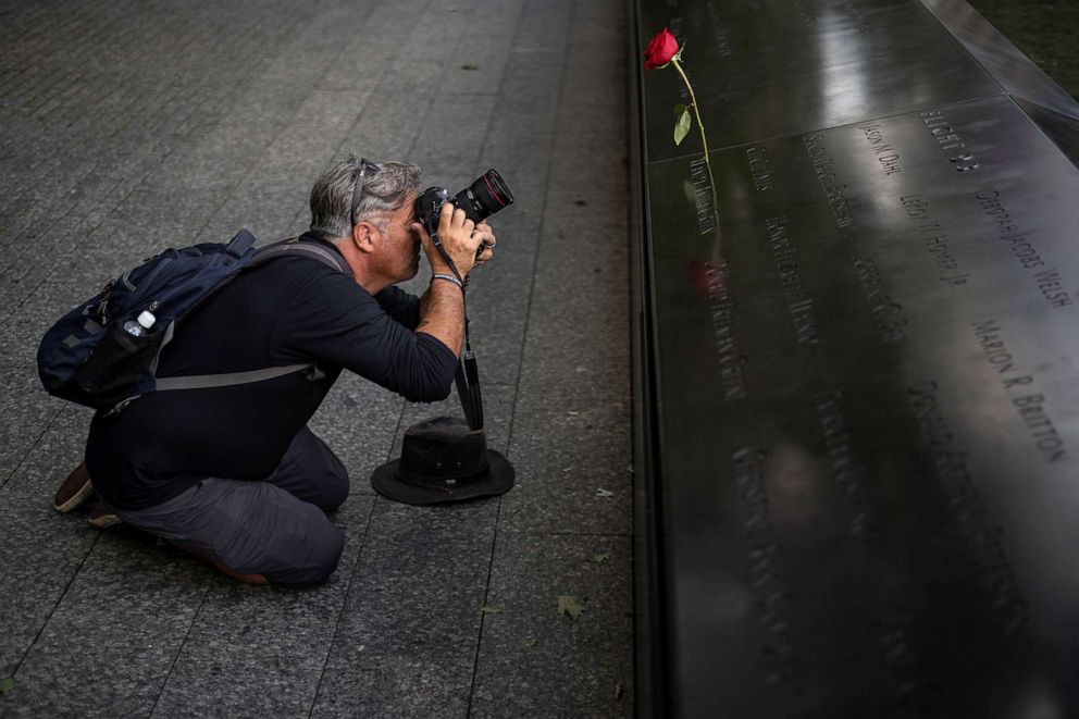 PHOTO: Shannon Stapleton takes photos of the 9-11 Memorial in New York, Sept 2, 2021. 