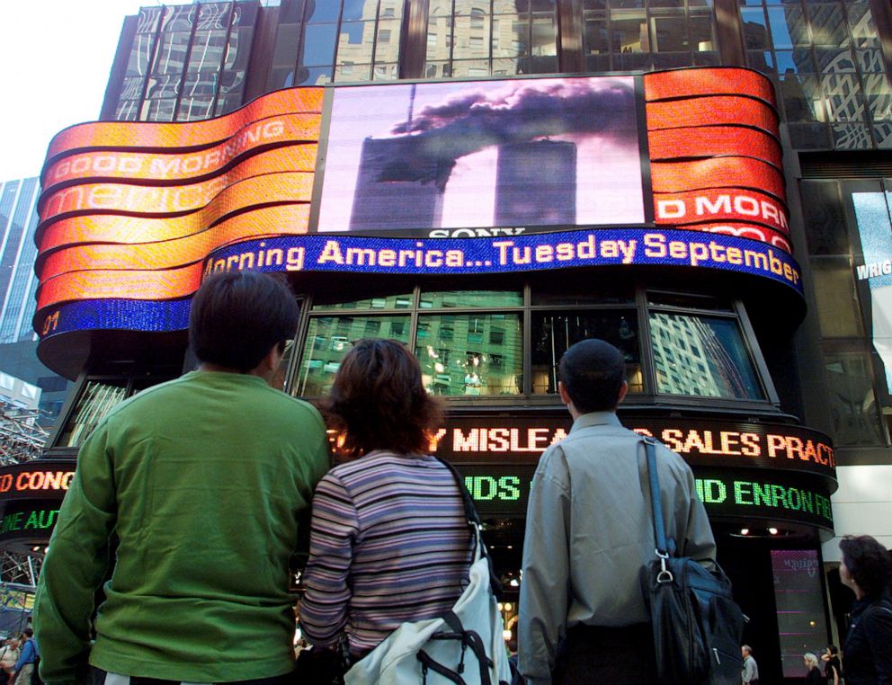 PHOTO: People in Times Square watch the World Trade Centre fire live on large screen televisions in New York, Sept. 11, 2001. 