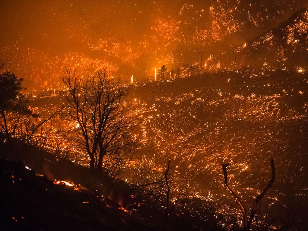 PHOTO: The foothills of the Santa Ynez mountains glow shortly after the fire front of the Thomas Fire passed through Monday night on Dec. 11, 2017, in Montecito, Calif.