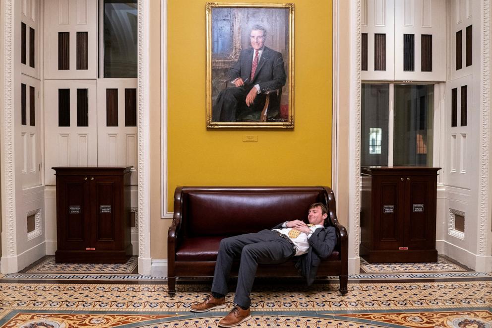 PHOTO: A senate staffer rests outside the Senate chamber as Republican lawmakers struggle to pass President Donald Trump's sweeping spending and tax bill, on Capitol Hill in Washington, D.C., on U.S., July 1, 2025.