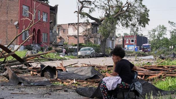 People survey damage after a severe storm moved through Friday, May 16, 2025, in St. Louis. 