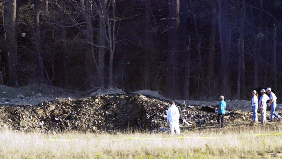 PHOTO: Emergency workers look at the crater created when United Airlines Flight 93 crashed near Shanksville, Pa., Sept. 11, 2001.