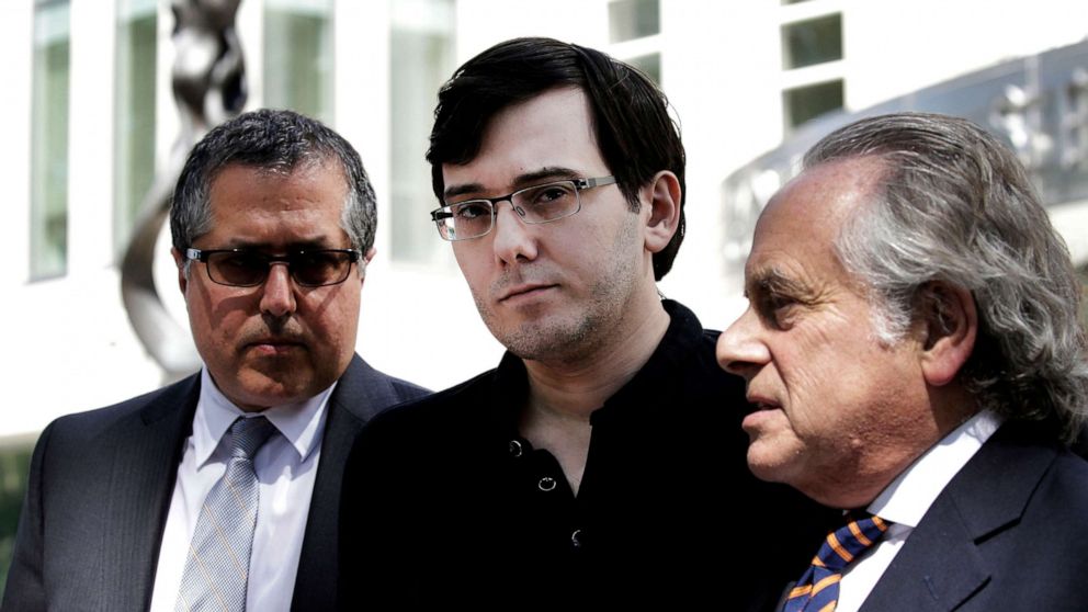 PHOTO: Martin Shkreli, former chief executive officer of Turing Pharmaceuticals AG, center, listens while his attorney Benjamin Brafman, right, speak to members of the media outside federal court in Brooklyn, N.Y., Aug. 4, 2017.