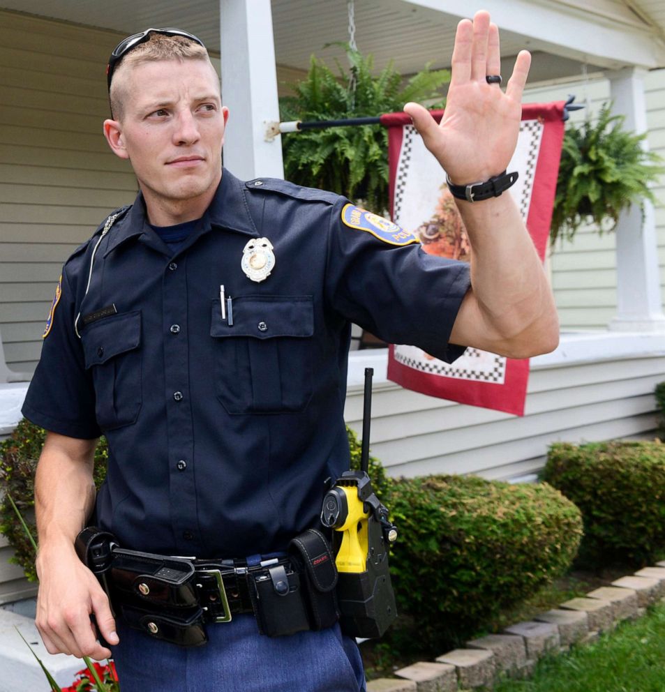 PHOTO: Grand Rapids Police Officer Christopher Schurr stops to talk with a resident, Aug. 12, 2015, in Grand Rapids, Mich. 