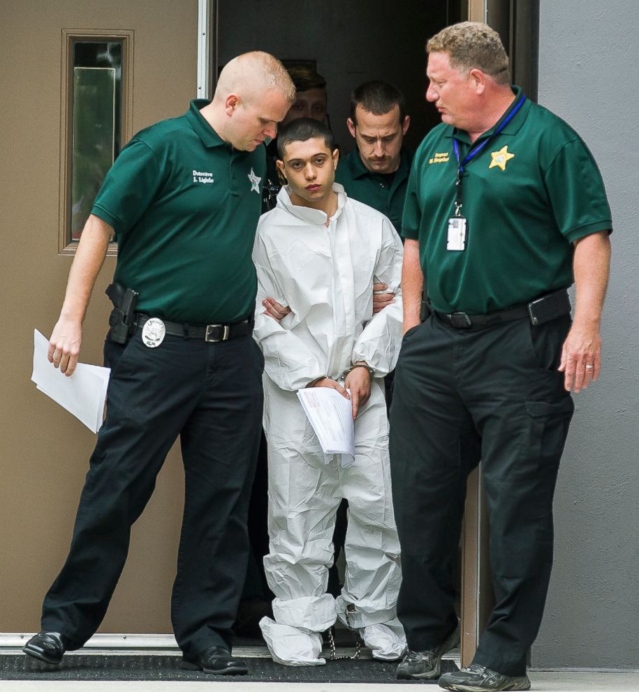 PHOTO: Marion County Sheriff's Detectives escort a handcuffed and shackled Sky Bouche, 19, center, to a waiting patrol car, April 20, 2018, in Ocala, Fla.