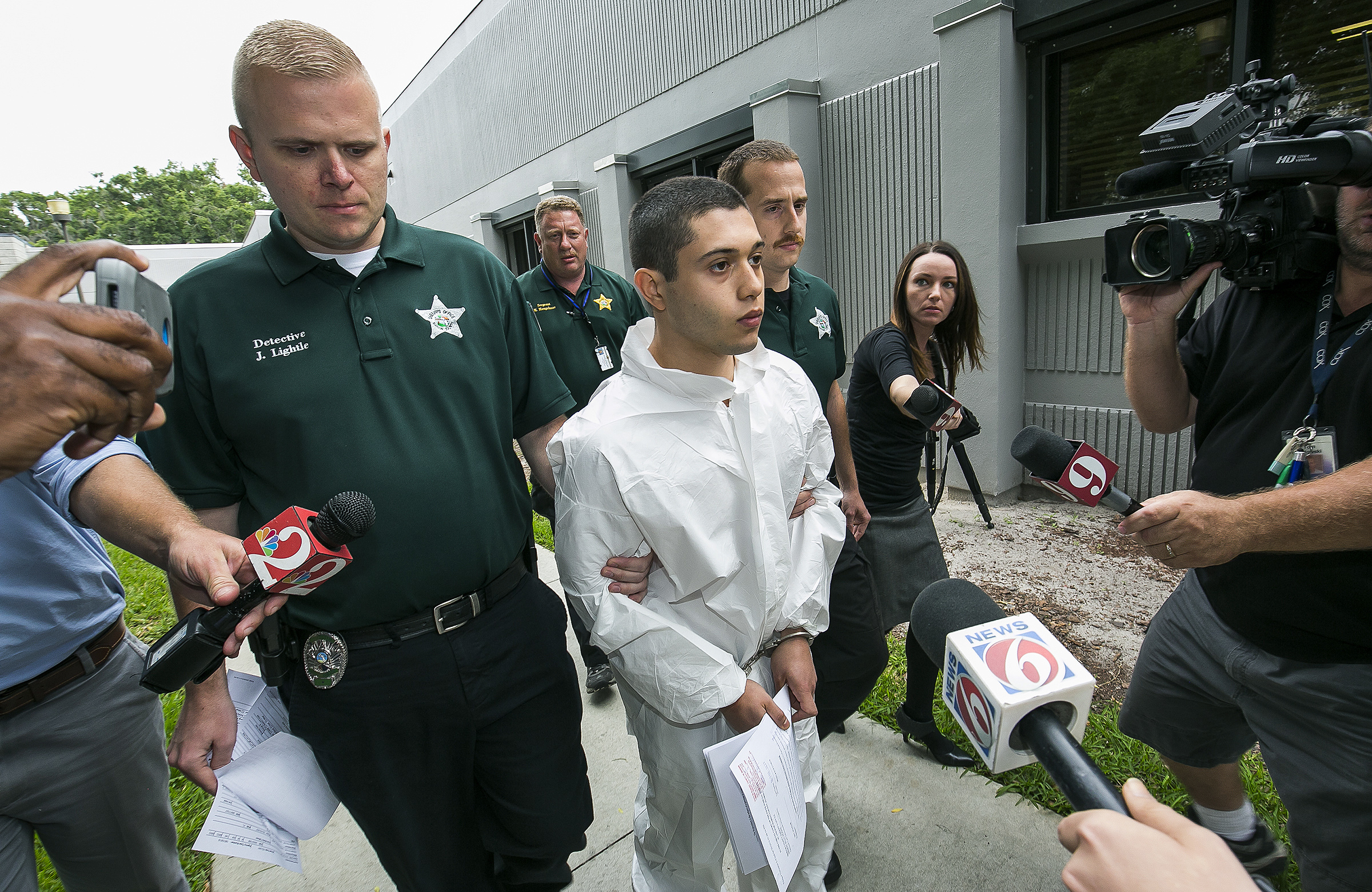PHOTO: Marion County Sheriff's Detectives escort a handcuffed and shackled Sky Bouche, 19, center, to a waiting patrol car, April 20, 2018, in Ocala, Fla.