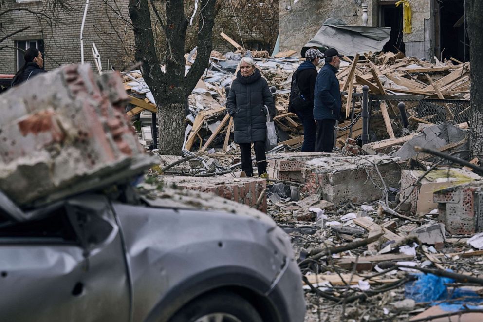 PHOTO: People stand in front of a heavily damaged building after a Russian attack in Sloviansk, Donetsk region, Ukraine, March 27, 2023.