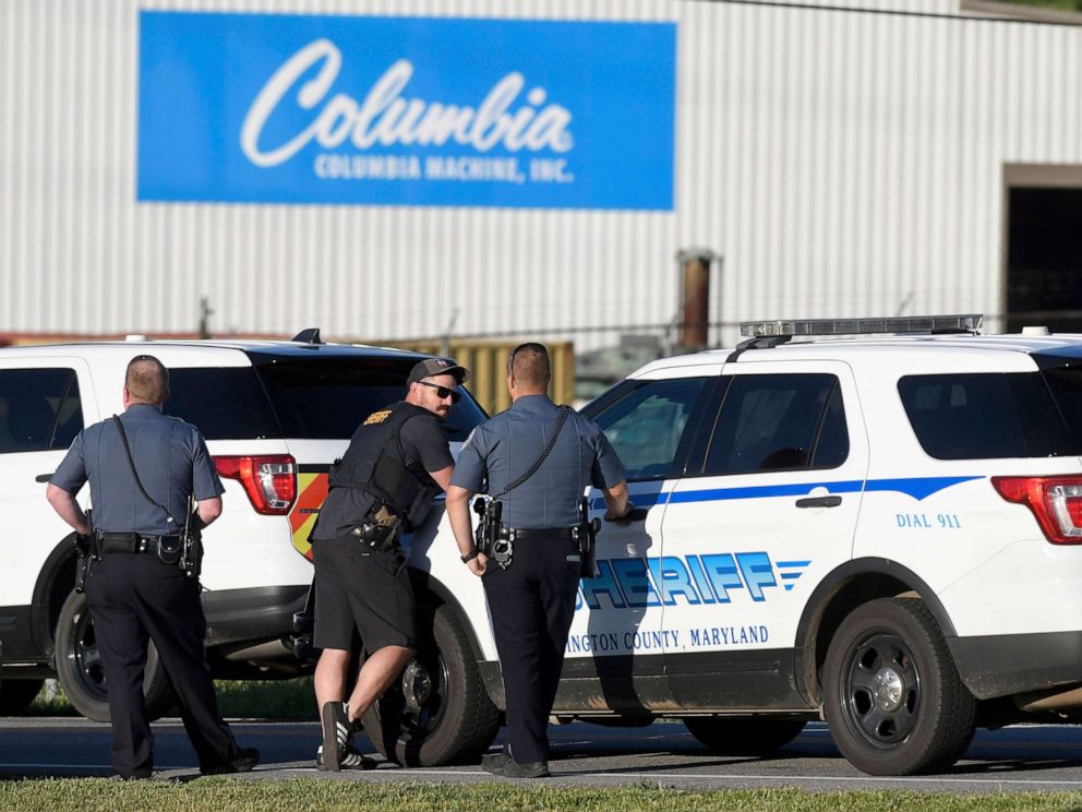 PHOTO: Police stand near where a man opened fire at a business, killing three people before the suspect and a state trooper were wounded in a shootout, according to authorities, in Smithsburg, Md., June 9, 2022.