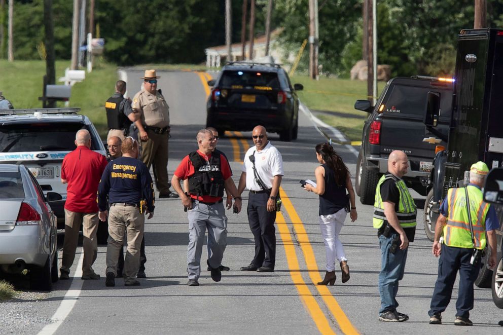 PHOTO: Law enforcement officials gather on the roadway outside the entrance to Columbia Machine Inc., June 9, 2022, near Smithsburg, Md. 