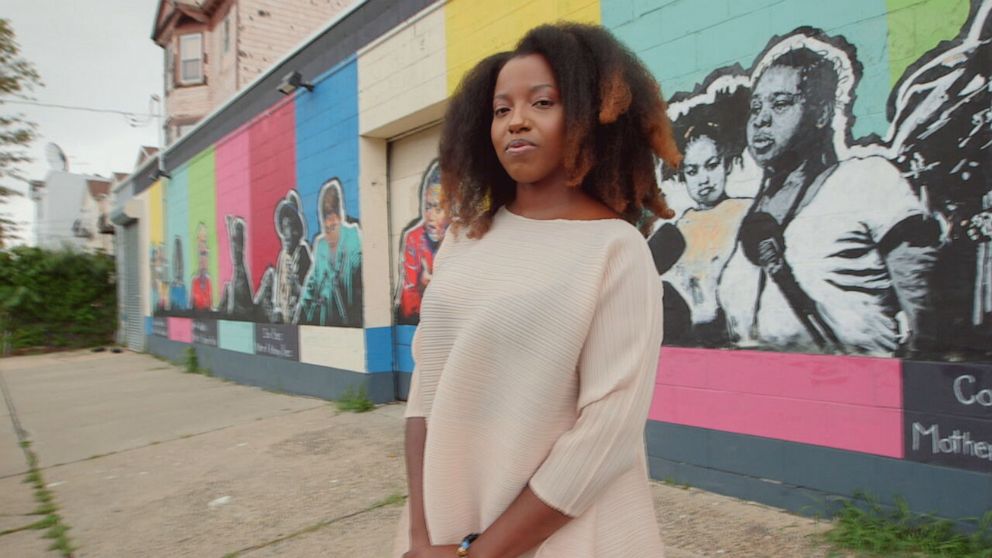 PHOTO: Artist Sophia Dawson standing in front of her "Every Mother" mural in Newark, New Jersey. 