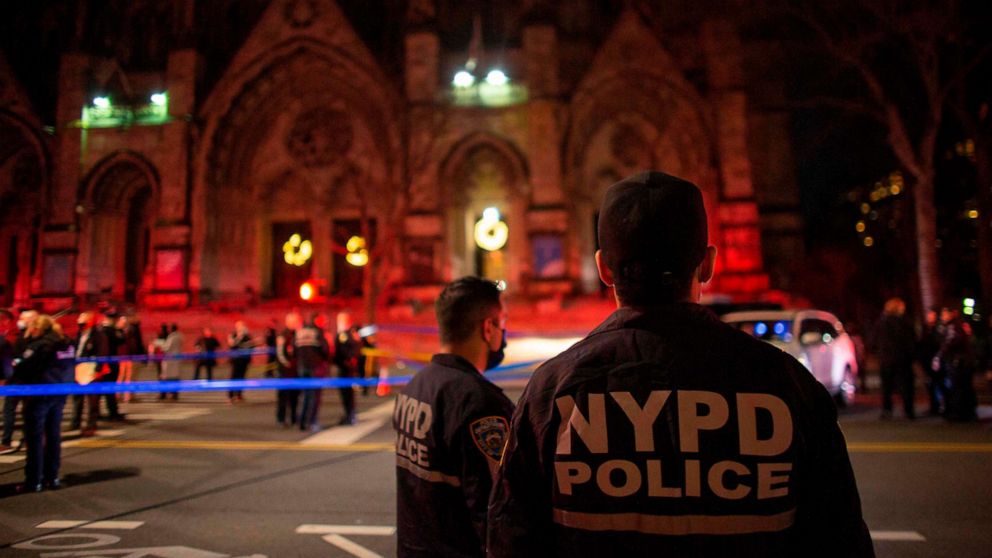 PHOTO: Police officers stand guard outside of the Cathedral of St. John the Divine in New York on December 13, 2020, after a shooter opened fire outside the church. 