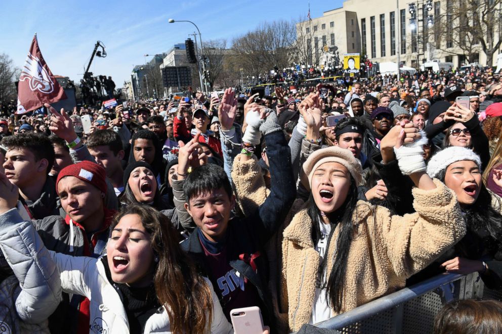 PHOTO: Marjory Stoneman Douglas High School students sing along to Miley Cyrus during the March for Our Lives protest march on March 24, 2018 in Washington. 